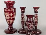 three red vases sitting next to each other on a table