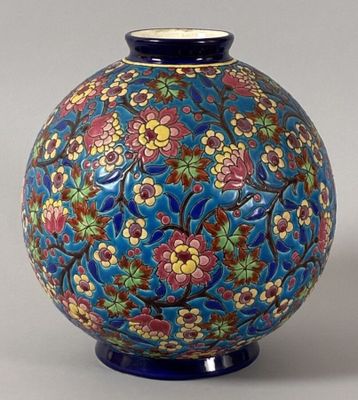 a blue vase with a floral design on it