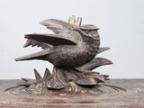 a bird that is sitting on top of a wooden box