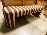 a striped bench that is sitting on the floor