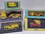 three boxed toy cars in boxes on a white surface