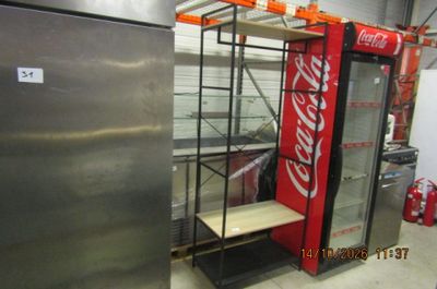 a coca cola machine in the middle of a room
