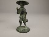 bronze figurine of a boy with a hat on his head