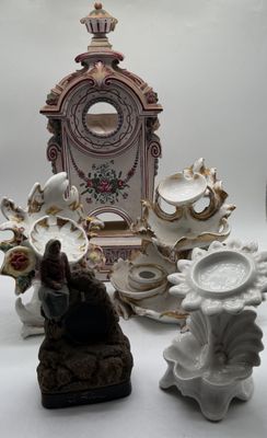 several figurines and a clock are sitting on a table