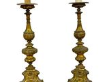 pair of antique brass candlesticks with candles in the form of lions