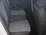 the back seats of a white car with the door open