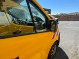 a yellow van that is parked in a parking lot