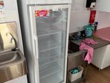 a refrigerator with a pink sign on it in a kitchen