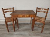 a small table and two chairs in a room
