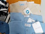 a lot of clothes that are sitting on a table