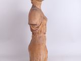 sculpture of a woman standing on a white surface with a white background