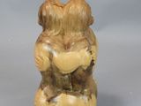 a small figurine of a bear holding a heart