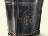 a black and gold planter sitting on a white surface