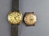 two watches sitting next to each other on a table