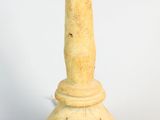 a small vase that is sitting on a white surface