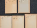 four pieces of paper with writing on them sitting on a table