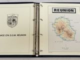 a black binder with a map of france and a map of reunion