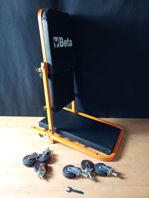 a wooden table with a black chair and some keys on it