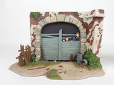 a figurine of a man and a dog in a stable