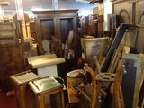 a room filled with lots of old wooden furniture