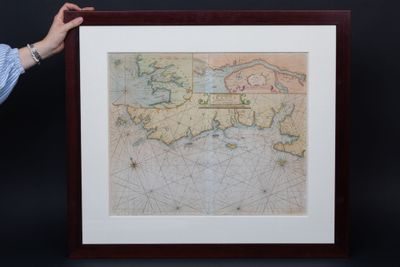 someone is holding a picture of a map in front of a black background