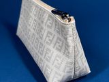 a small white purse with a zipper closure on a blue background