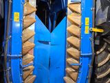 a large blue tractor with a big wheel behind it