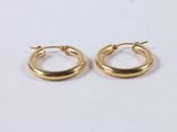 a pair of gold hoop earrings on a white background