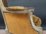 an old fashioned chair with a gold velvet upholstered seat