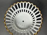 an image of a white and gold bowl on a gray surface