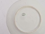 a white plate with a green design on it