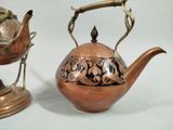 two teapots sitting next to each other on a table