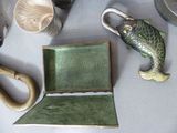 a green tray with a fish on it next to other items