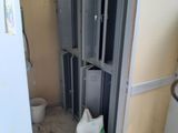 a trash can in the corner of a bathroom that is being remodeled