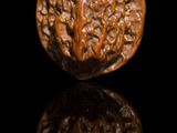 a wooden object that is sitting on a black surface