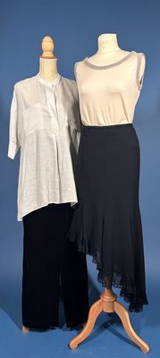 two women ' s dresses on a mannequin stand against a blue background