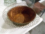 a metal basket with some food in it on a table