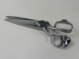 a pair of scissors sitting on a white surface