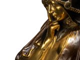 bronze statue of a woman with a hat on her head and a veil on her head