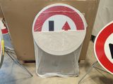 two signs that are sitting next to each other on the floor