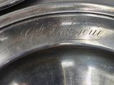 a close up of a silver plate with a name engraved on it
