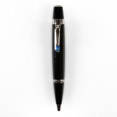 a close up of a pen on a white surface with a blue stripe