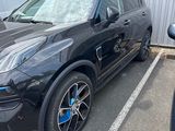 a picture of a black car parked in a parking lot