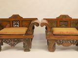 pair of antique carved wood chairs with upholstered cushions