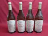 four bottles of wine are lined up on a red background