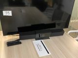 a flat screen tv sitting on top of a wooden table