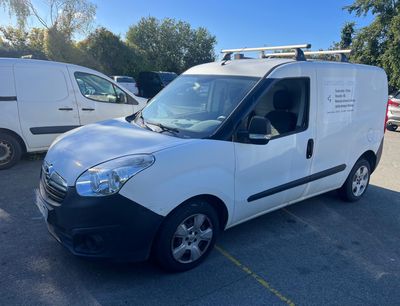 a white van parked in a parking lot next to other vehicles