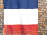 an image of a flag hanging on a brick wall in front of a brick wall