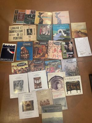 a lot of books on a table with a remote