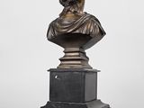 a bronze bust of a woman on a pedestal